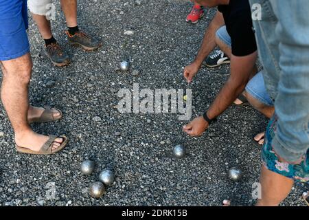 Illustration, game with balls from the south of France: players measuring the distance between the jack and a boule Stock Photo