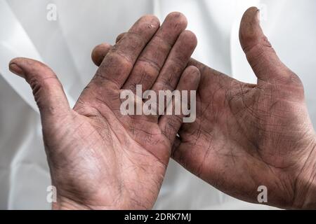 Strong wrinkled dirty hands of working man with calluses Stock Photo