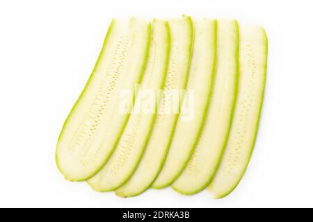 Thin slices of green zucchini isolated on white background Stock Photo