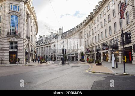 A view of a deserted Regent Street, as shops and businesses close once again. London has imposed even tougher restrictions as cases surge and a new strain of COVID-19 emerges in the capital and the South East of England. Stock Photo