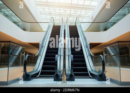 Graphic background image of architectural design with escalator in shopping mall or office building under construction, copy space Stock Photo