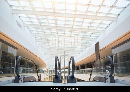 Graphic background image of modern shopping mall with glass roof and escalators in foreground, copy space Stock Photo