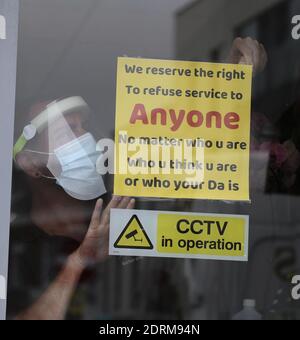 Shopkeeper put up a sign during the Covid-19 after Northern Ireland's health minister has said he will be recommending Covid-19 restrictions to the executive to curb the increasing spread of the disease.Robin Swann said 'we have to step in now' to deal with a rise in new cases.On Wednesday, 34 new Covid-19 cases were confirmed by the Department of Health. No deaths were announced so its death toll remains at 559 Picture by Hugh Russell Stock Photo