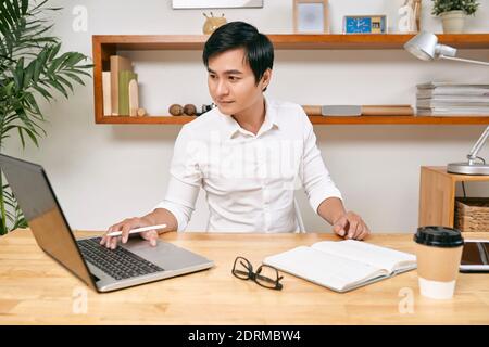 Businessman checking data on laptop Stock Photo