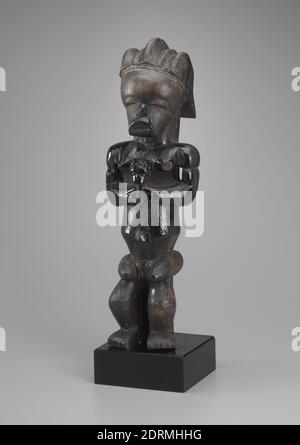 Female Guardian Reliquary Figure (Byeri) holding a Staff (?) with a Human Head, 19th century, Wood from the Rubiaceae tree family and oil, 19 1/2 × 6 1/2 × 4 1/2 in. (49.53 × 16.51 × 11.43 cm), Made in Gabon, Fang Mvai, 19th century, Sculpture Stock Photo