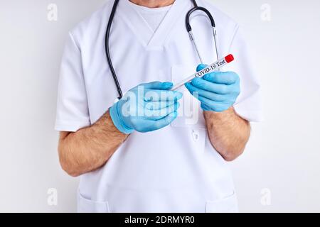 cropped doctor male holding coronavirus test in tube , close-up photo. isolated white background Stock Photo