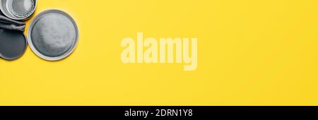 Gray empty ceramic plates on yellow Stock Photo