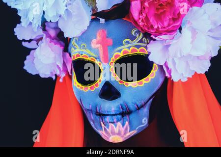 Creative image of Sugar Skull. Neon makeup for Halloween or Dia De Mertos holiday. Stock Photo