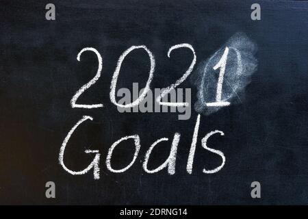 2020 crossed 2021 goals written word on the blackboard. Stock Photo