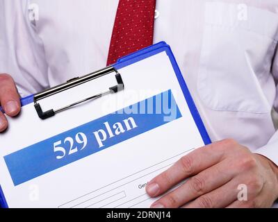 Manager offers to sign the 529 plan application. Stock Photo