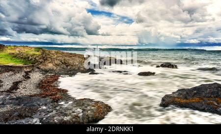 A panoramic view across Belfast Lough on the North Down Coastal Path between Helen's Bay and Seahill, County Down, Northern Ireland. Stock Photo