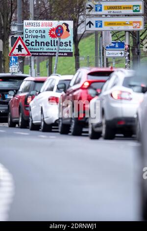 Cologne, Germany. 21st Dec, 2020. Motorists wait in front of the Corona quick test drive-in at the Lanxess Arena. Motorists can be tested directly in their cars in a multi-storey car park at the arena. Credit: Marius Becker/dpa/Alamy Live News Stock Photo