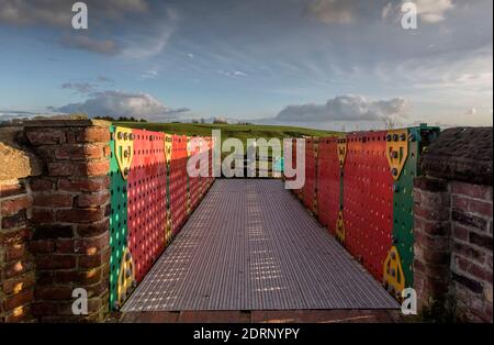 Manchester, Bolton and Bury Canal in Little Lever, Bolton. A man admires the view from the unique 'Meccano' bridge on a glorious winter day. Picture b Stock Photo