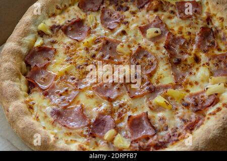 Closeup top view of delicious hawaiian pizza with cheese , bacon and pineapple. Stock Photo