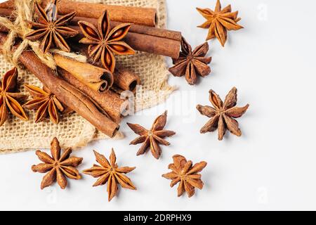 Spices for making mulled wine.Cinnamon sticks with star anise on a white plate. Stock Photo
