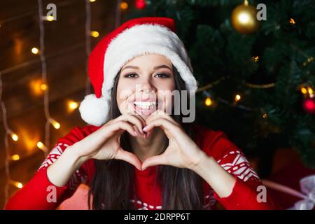 Portrait of beautiful woman wear santa hat on Christmas background. Merry Christmas and Happy Near Year