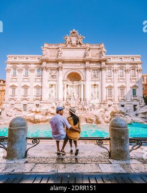 young couple mid age on a city trip in Rome Italy Europe, couple sightseeing visit Fontana di Trevi in Rome Italy Stock Photo