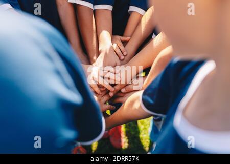 Group of kids stacking hands Stock Photo - Alamy