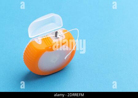 Dental floss box on blue background Stock Photo