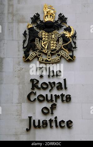 United Kingdom, England, London. The Royal Courts of Justice (Law Courts). Exterior detail. Name of The Royal Courts of Justice (Law Courts) and the Royal coat of arms of the United Kingdom. Stock Photo