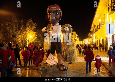 Cusco, Peru - June 24, 2015: Inti Raymi, Festival of the Sun, is celebrated in the streets of Cusco with parades of music and large paper mache floats Stock Photo