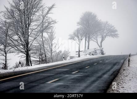 Winterberg, Sauerland, North Rhine-Westphalia, Germany - snowy landscape with empty country road. Stock Photo