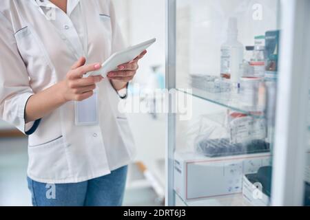Female doctor using touchpad in medical clinic Stock Photo