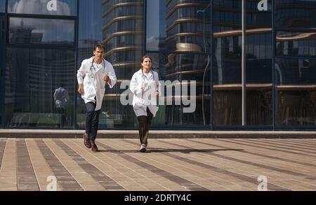 in full growth. medical professionals running to the rescue. Stock Photo