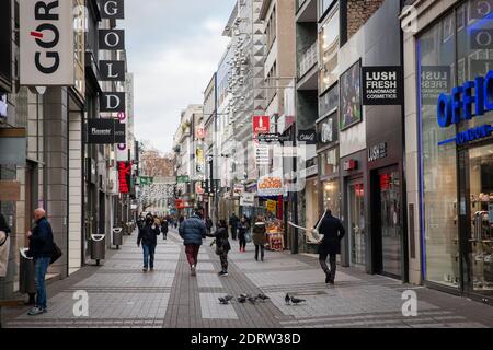 Corona Lockdown, December 16th. 2020. Only few people on shopping street Hohe Strasse, usually visited by thousands of people, Cologne, Germany.  Coro Stock Photo