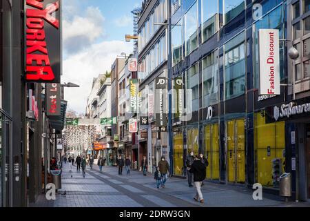 Corona Lockdown, December 17th. 2020. Only few people on shopping street Hohe Strasse, usually visited by thousands of people, Cologne, Germany.  Coro Stock Photo