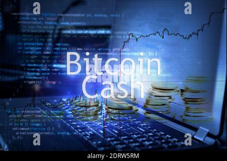 Bitcoin cash inscription against laptop and code background.  Cryptocurrency concept. Stock Photo