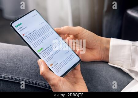 woman using phone to read customer reviews about service and product quality before online shopping Stock Photo