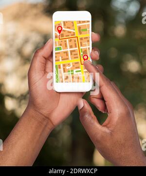 Black Man Using Modern GPS Navigation App Opened On Smartphone, Creative Collage Stock Photo