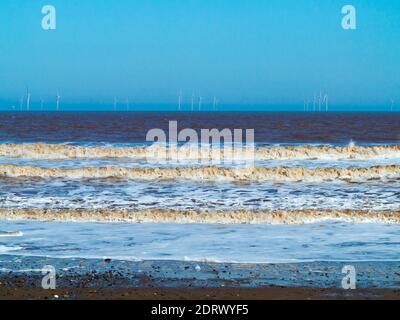 Offshore wind turbines on the horizon of the North Sea seen from Withernsea in the East Riding of Yorkshire England UK Stock Photo