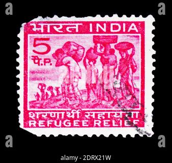 MOSCOW, RUSSIA - FEBRUARY 10, 2019: A stamp printed in India shows Compulsory supplement brand in favor of the refugees, Obligatory postal tax for Ref Stock Photo