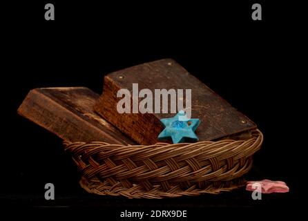 Very old and worn out books and old rattan basket with black background Stock Photo