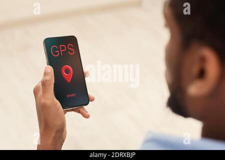 Gps App. Black Man Holding Smartphone With Opened Navigation Application On Screen Stock Photo