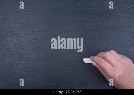 Abstract texture of chalk rubbed out on blackboard or chalkboard with a chalk and hand Stock Photo
