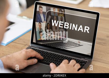 Unrecognizable man having webinar on laptop while working in office Stock Photo