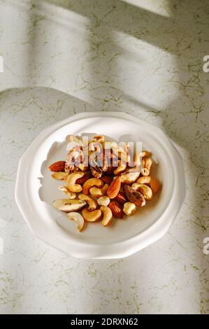 Bowl of raw nuts on residential kitchen counter Stock Photo