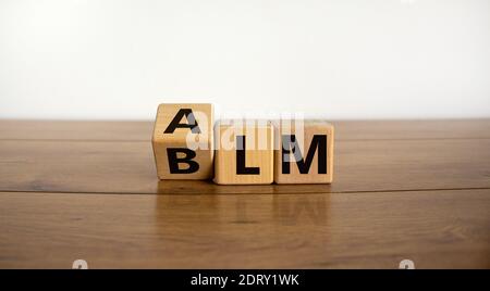 BLM vs ALM symbol. Turned cubes and changed word 'BLM - black lives matters' to 'ALM - all lives matters'. Beautiful white background. Business and BL Stock Photo