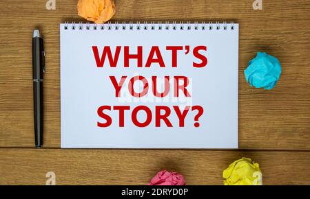Your story symbol. White note with inscription 'what is your story' on beautiful wooden table, colored paper, metalic pen, drawn light bulb and wrench Stock Photo