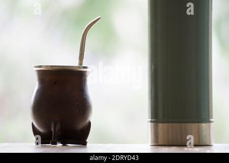 Selective Focus Shot Of A Hand Pouring Water From A Thermos In Calabash Mate  Cup With Straw Stock Photo - Download Image Now - iStock