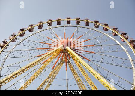 Yellow ferris wheel in an amusement park.  Stock Photo