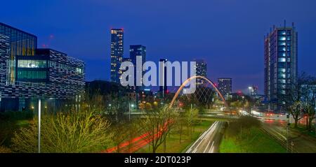 Modern 2021 Manchester skyline from south with Hulme Arch featuring and part of Manchester Metropolitan University on left. Stock Photo