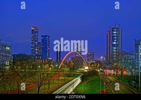 Modern 2021 Manchester skyline from south with Hulme Arch featuring and part of Manchester Metropolitan University on left. Stock Photo