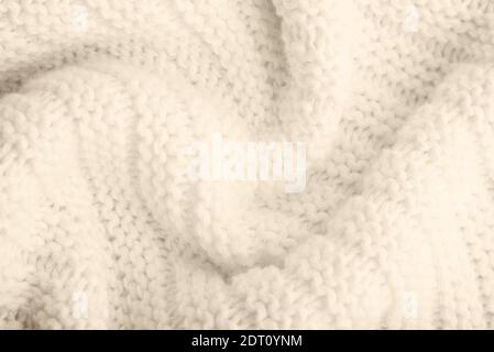 Close up of beige knitted textured background. Trendy color. Stock Photo