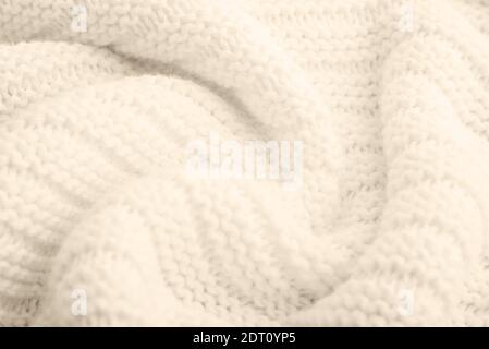 Close up of beige knitted textured background. Trendy color. Stock Photo