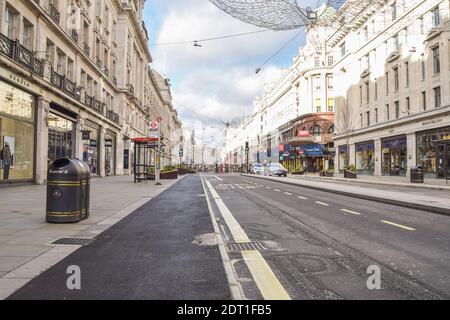 A view of a deserted Regent Street, as shops and businesses close once again. London has imposed even tougher restrictions as cases surge and a new strain of COVID-19 emerges in the capital and the South East of England. Stock Photo