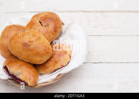 Homemade patties with berries on white wooden background with a copy space Stock Photo